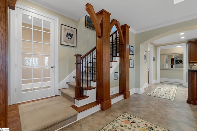 staircase with tile patterned flooring and crown molding