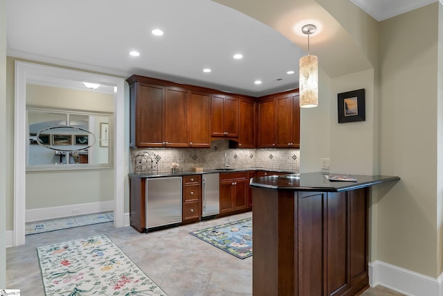 kitchen featuring sink, tasteful backsplash, fridge, decorative light fixtures, and kitchen peninsula