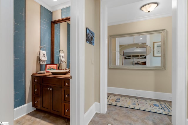 bathroom featuring crown molding, tile patterned flooring, and vanity