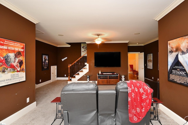 home theater with ceiling fan, light colored carpet, and crown molding