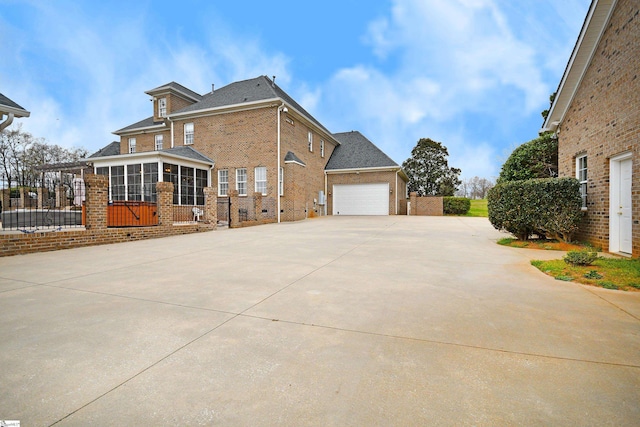 view of home's exterior featuring a sunroom and a garage