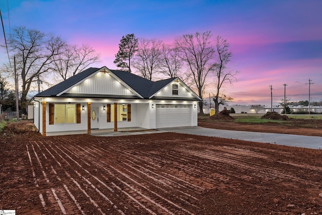 view of front of property with a garage and covered porch