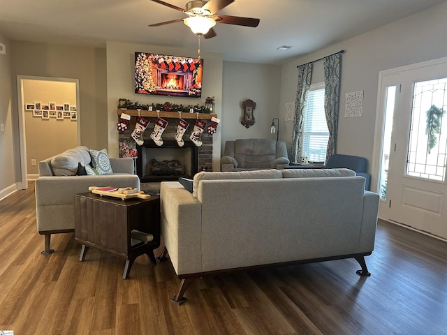 living room featuring ceiling fan and hardwood / wood-style flooring