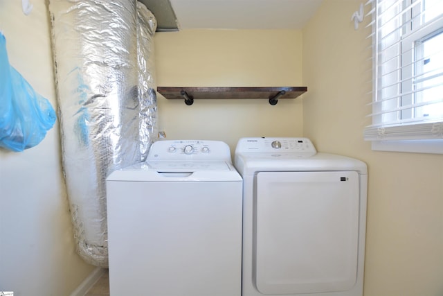 clothes washing area featuring washer and clothes dryer