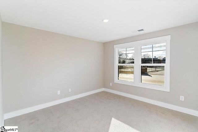 empty room featuring light carpet