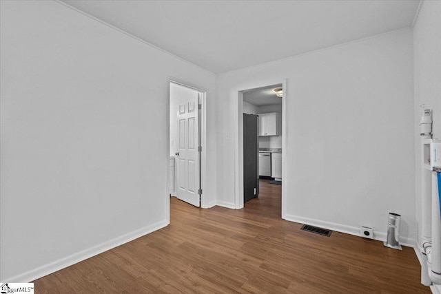 unfurnished room with hardwood / wood-style flooring