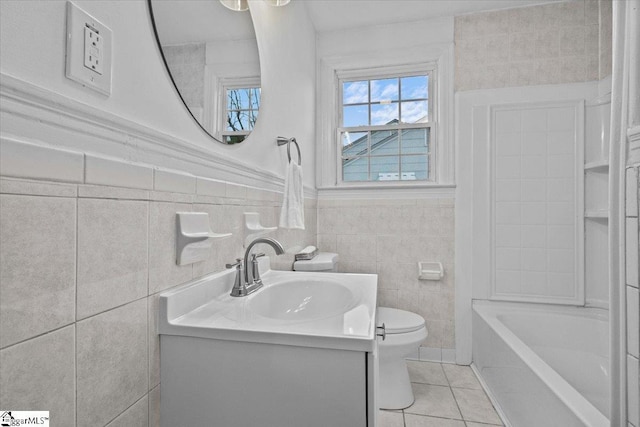 full bathroom featuring tile patterned floors, vanity, tile walls, washtub / shower combination, and toilet