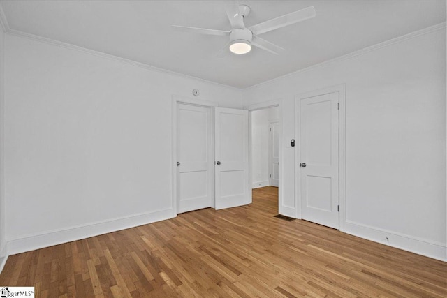 unfurnished bedroom with ceiling fan, crown molding, and light hardwood / wood-style floors