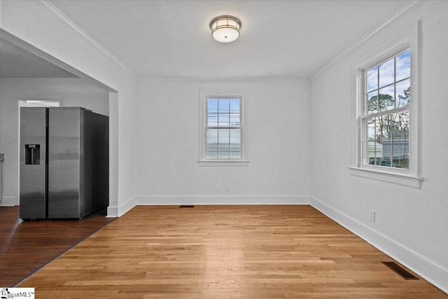 unfurnished room with light hardwood / wood-style floors and ornamental molding