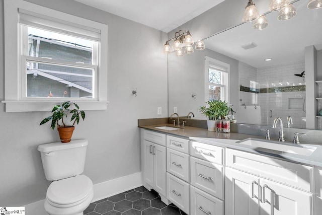 bathroom with toilet, vanity, tile patterned floors, and a shower with door