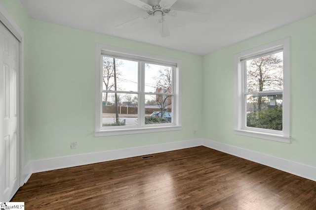 spare room featuring wood-type flooring and ceiling fan