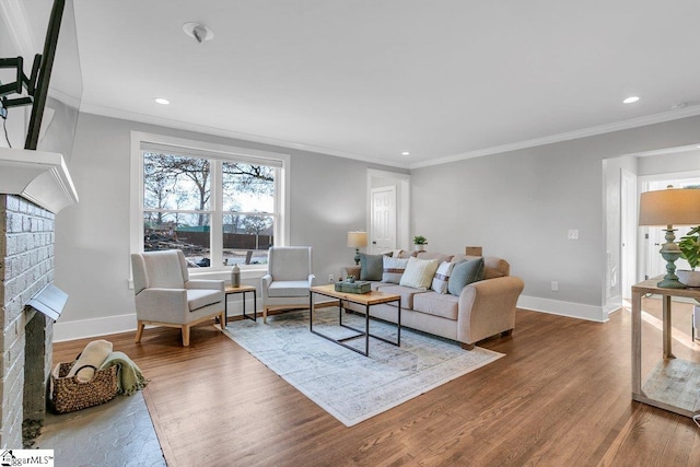 living room featuring a fireplace, wood-type flooring, and ornamental molding