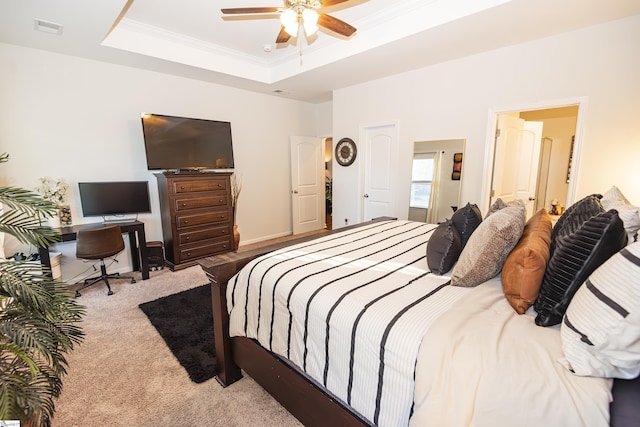 bedroom featuring ceiling fan, a raised ceiling, light colored carpet, and ornamental molding