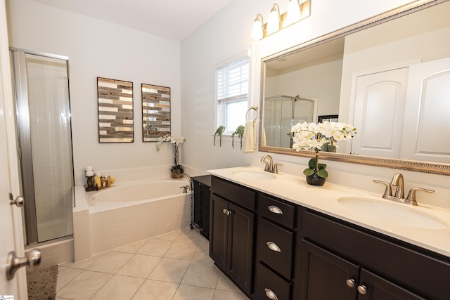 bathroom featuring tile patterned flooring, vanity, and separate shower and tub