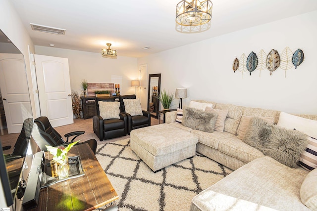 living room featuring light colored carpet and an inviting chandelier