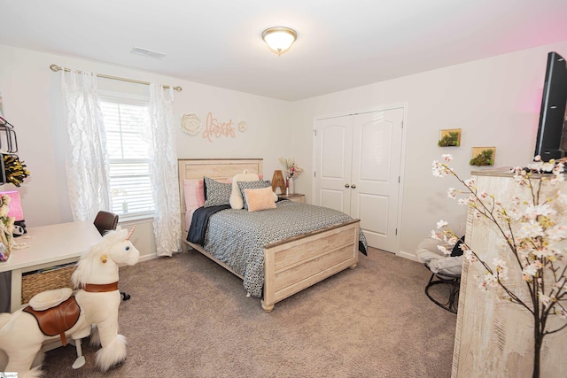 bedroom with a closet and carpet floors