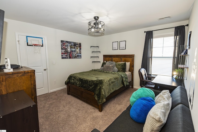 bedroom featuring carpet and a notable chandelier