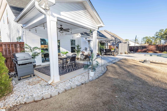 view of patio with ceiling fan and a grill