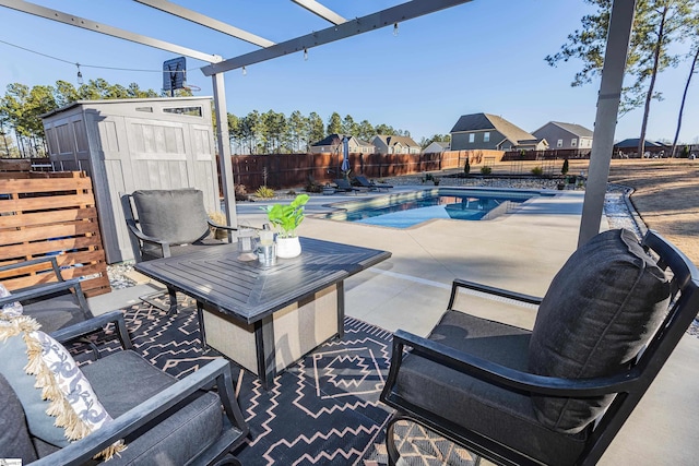 view of patio / terrace featuring a fenced in pool and a storage unit