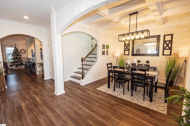 dining room with beamed ceiling, ornamental molding, dark wood-type flooring, and coffered ceiling