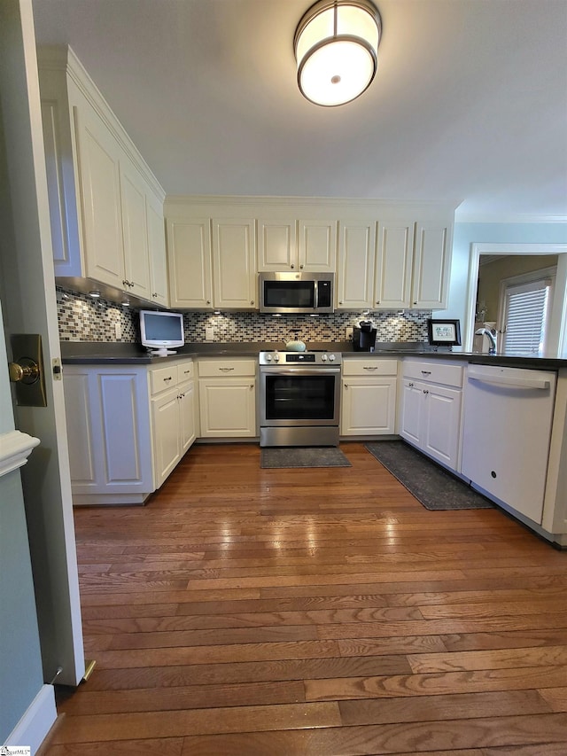 kitchen with white cabinetry, dark hardwood / wood-style flooring, and stainless steel appliances