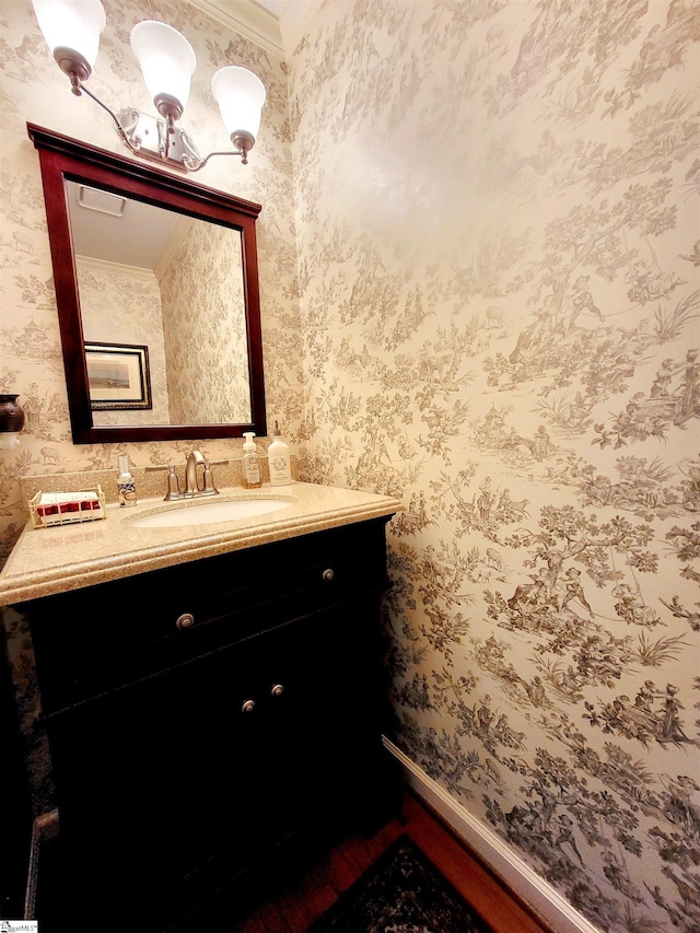 bathroom with vanity, wood-type flooring, and crown molding