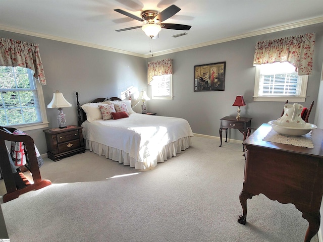 carpeted bedroom featuring ceiling fan and ornamental molding