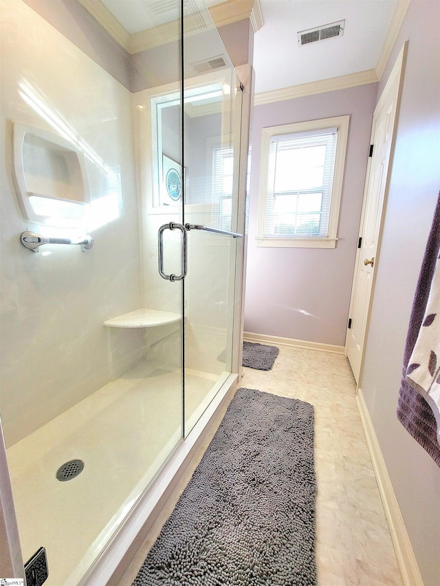 bathroom with a shower with door and ornamental molding