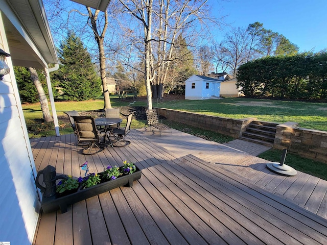 deck with a yard and a shed