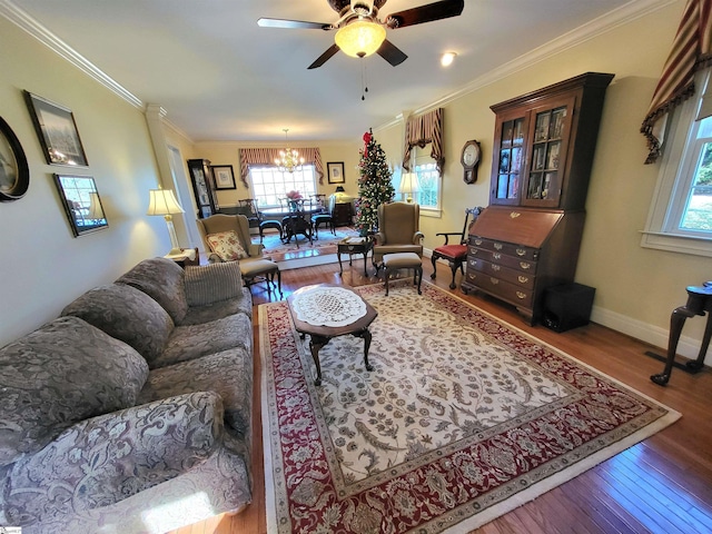 living room with crown molding, ceiling fan with notable chandelier, and hardwood / wood-style flooring