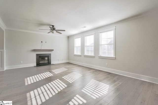 unfurnished living room with crown molding, ceiling fan, and hardwood / wood-style flooring