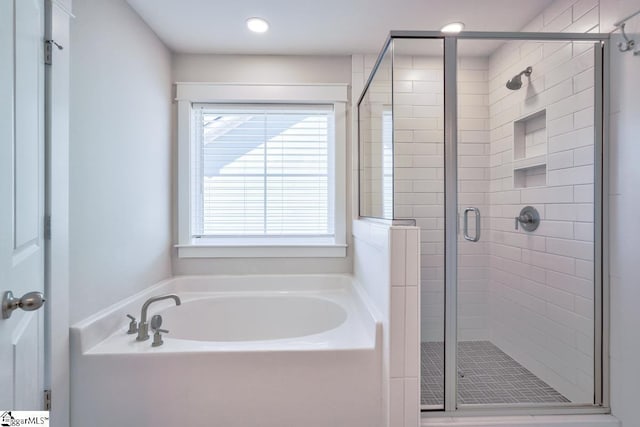 bathroom with shower with separate bathtub