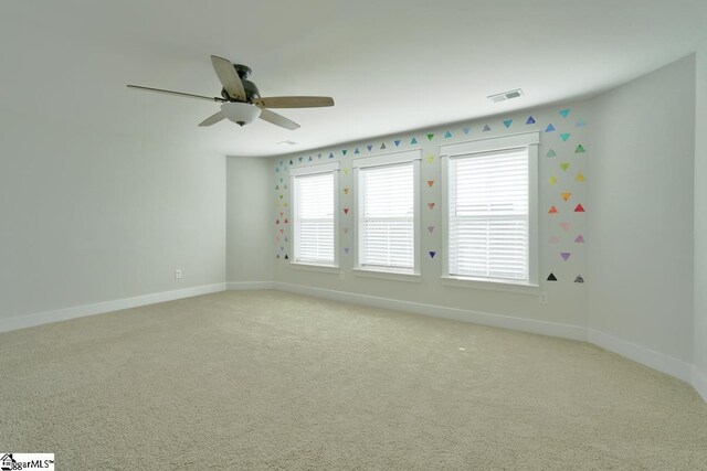 carpeted empty room featuring ceiling fan