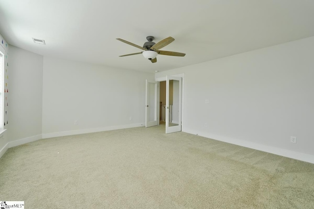 carpeted spare room with ceiling fan