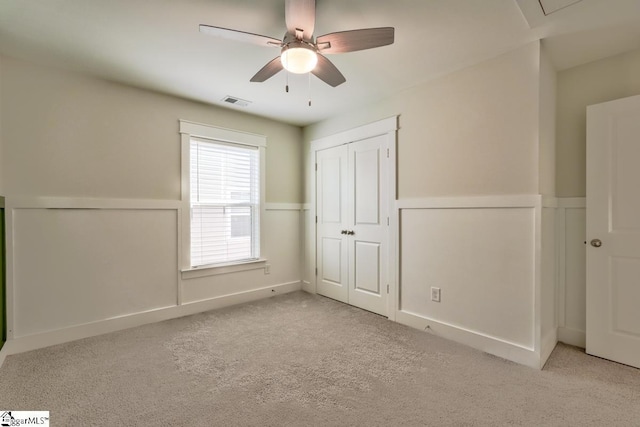 unfurnished bedroom with ceiling fan and light carpet