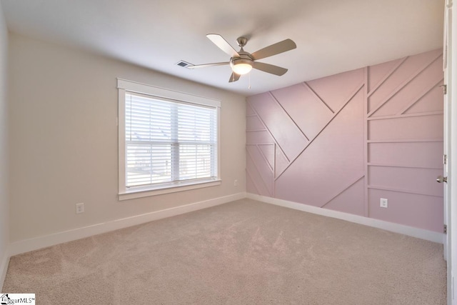 carpeted empty room featuring ceiling fan