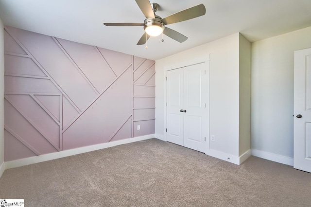 unfurnished bedroom with ceiling fan, a closet, and carpet