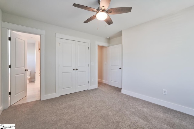 unfurnished bedroom featuring ceiling fan, light carpet, and a closet