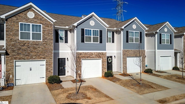 townhome / multi-family property featuring a garage