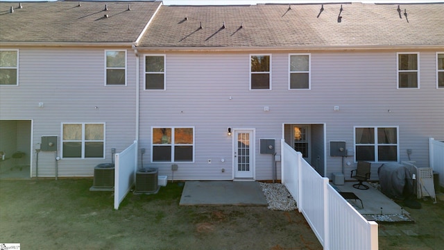 rear view of house with cooling unit and a patio