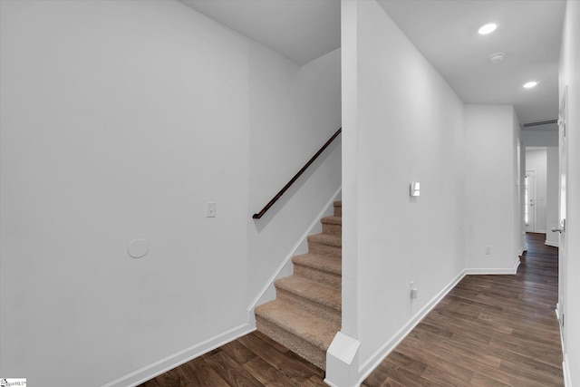 stairs featuring hardwood / wood-style flooring