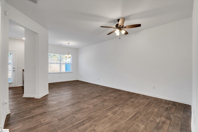 unfurnished room featuring ceiling fan with notable chandelier and dark hardwood / wood-style floors