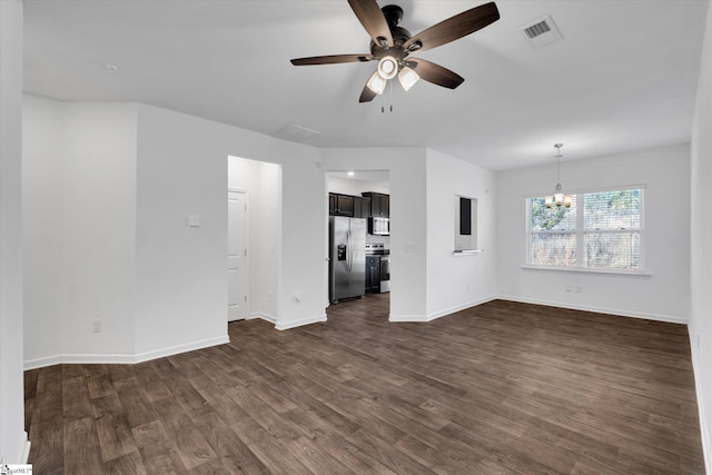 unfurnished living room with ceiling fan with notable chandelier and dark hardwood / wood-style floors