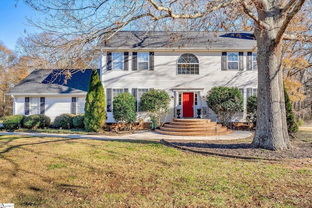 colonial-style house with a front yard