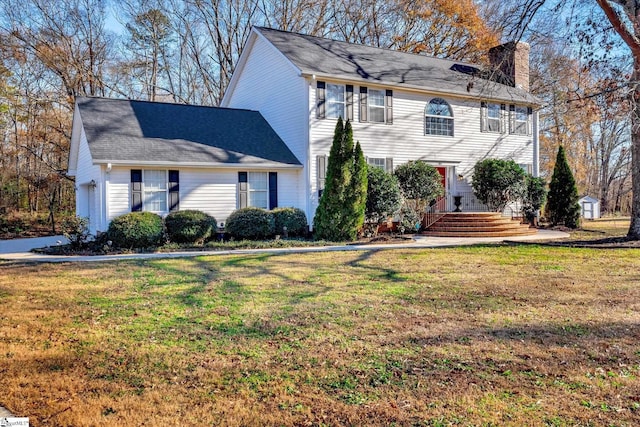 colonial home with a front lawn