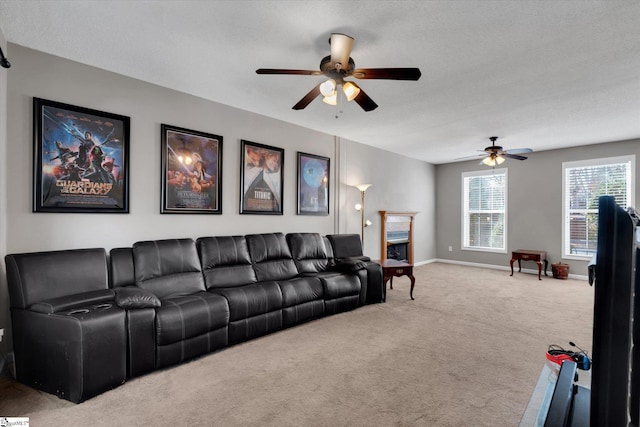 living room featuring carpet, a textured ceiling, and ceiling fan