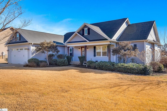 view of front of property featuring a front yard, a garage, and covered porch