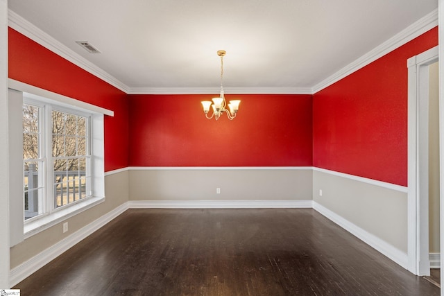 unfurnished dining area featuring crown molding, dark wood-type flooring, and an inviting chandelier