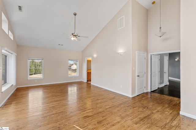 unfurnished living room with ceiling fan, light hardwood / wood-style floors, and high vaulted ceiling