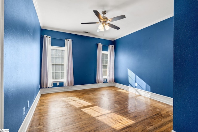 spare room featuring hardwood / wood-style floors, ceiling fan, and ornamental molding